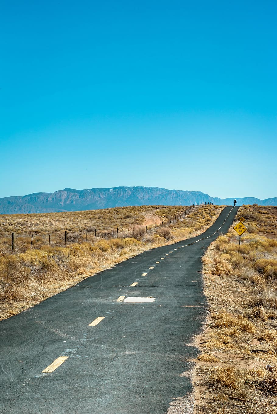road with brown grass under blue skies, scenery of deserted road HD wallpaper