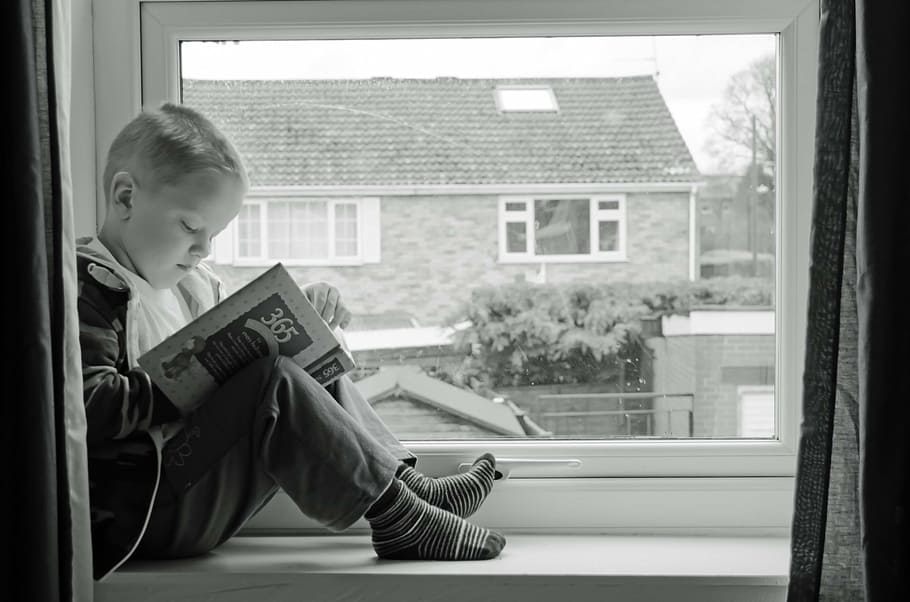 boy sitting on window reading book, learning, development, looking