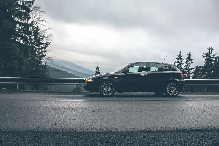 black car near road rails, black 5-door hatchback parked on road HD wallpaper