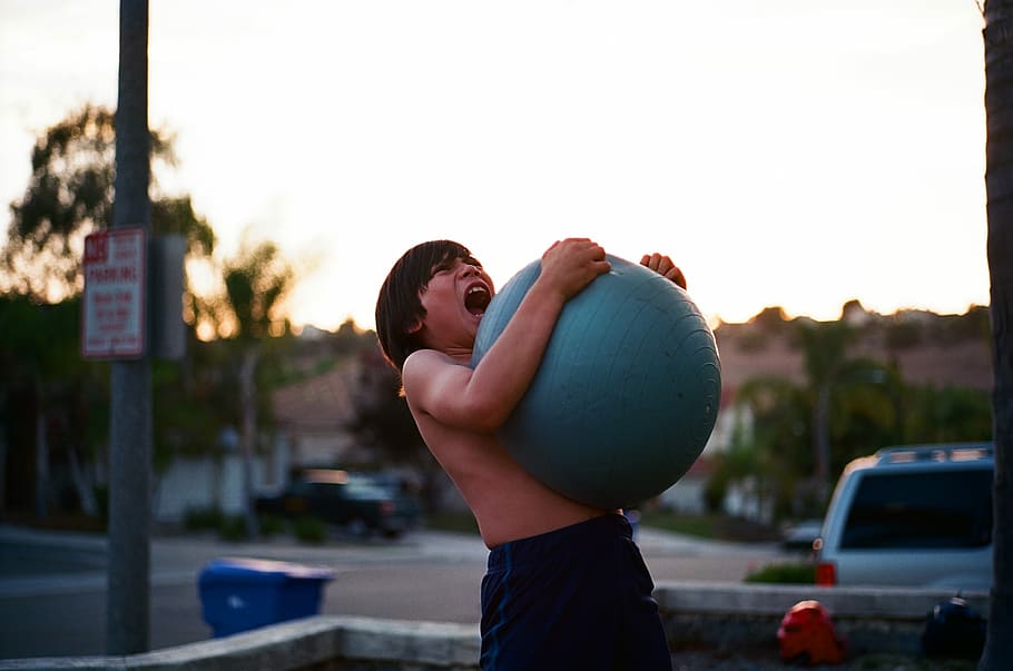 boy holding blue fitness ball, outdoors, adult, people, men, one Person HD wallpaper