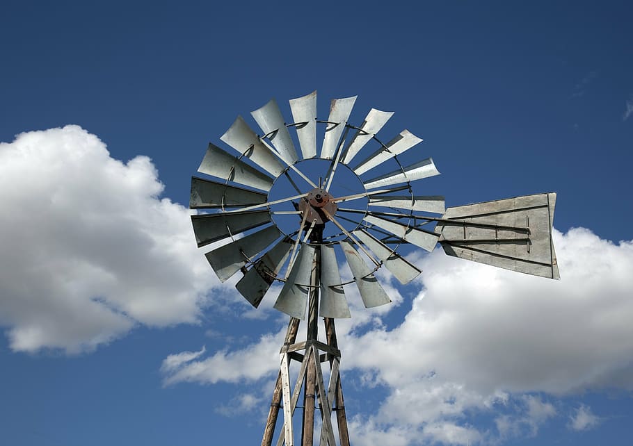 gray windmill under white clouds and blue sky, western, south dakota