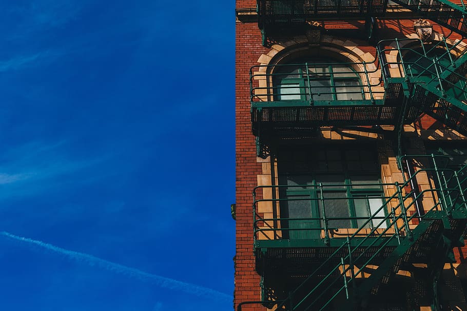 low angle photo of red brick building with fire exit stairway, HD wallpaper