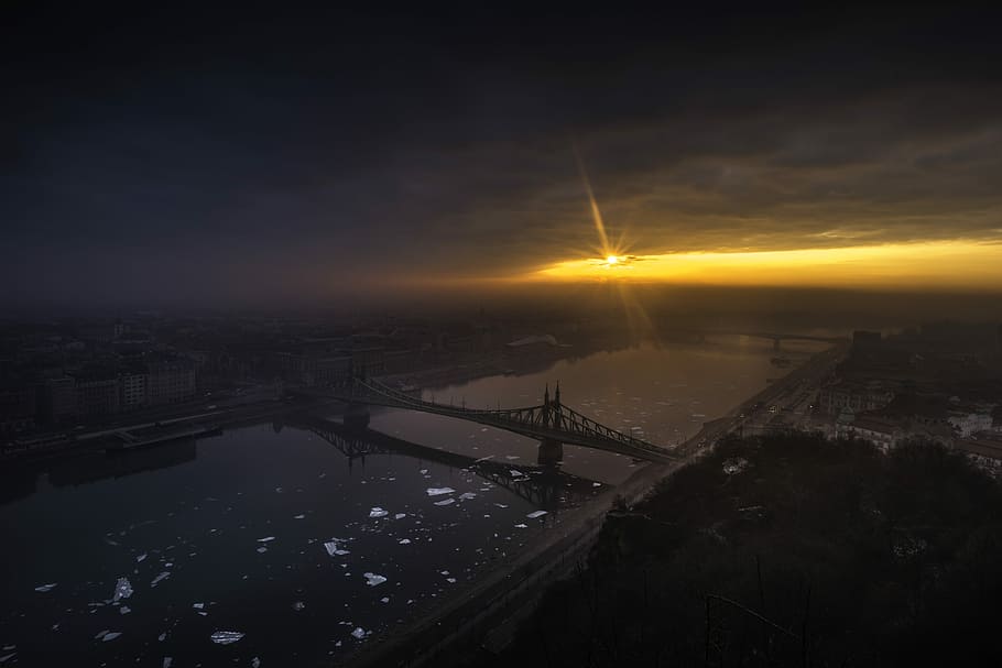 aerial photography of bridge on top of body of water at golden hour, aerial photography of city during sunrise HD wallpaper