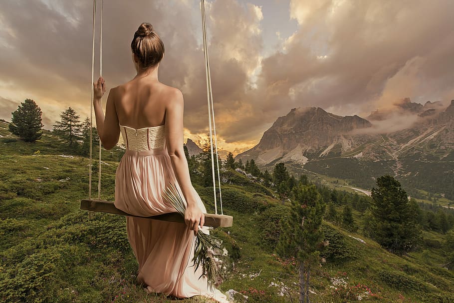 woman in maxi dress sitting on swing facing mountains, girl, female