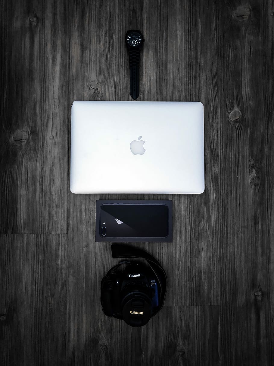 silver Macbook on grey table, silver MacBook, black Canon camera, iPhone 8 and watch on gray wooden floor HD wallpaper