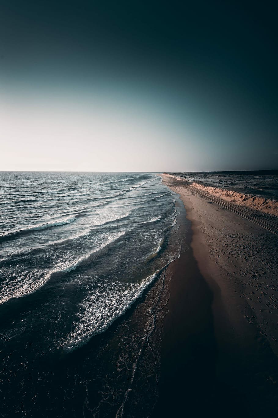 calm waves crashing on shore, landscape photo of shore, ocean