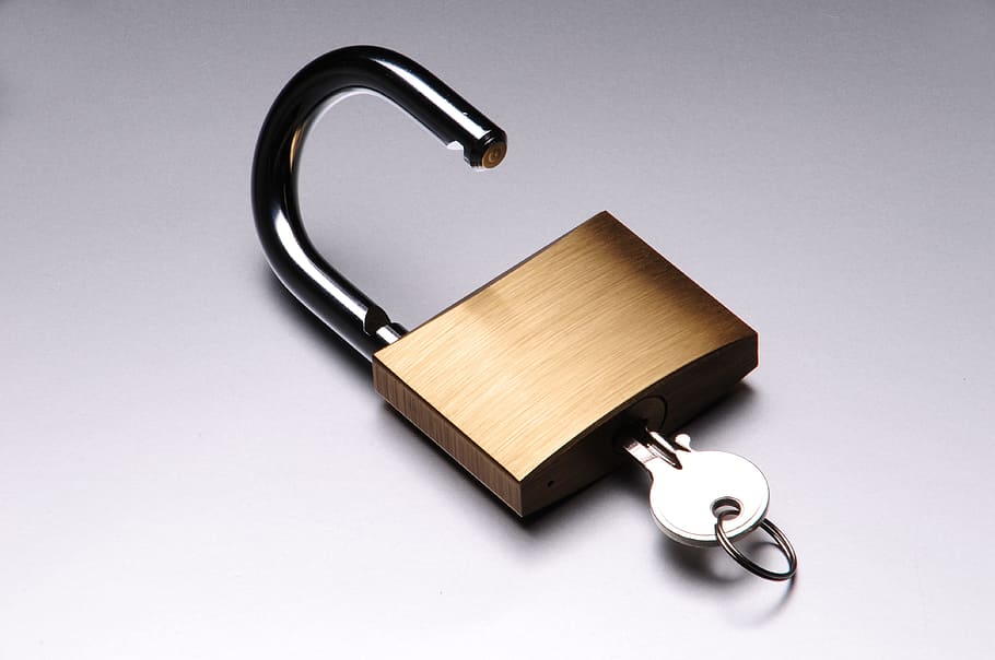 silver key inside brown pad lock, tools, padlocks, unlock, access