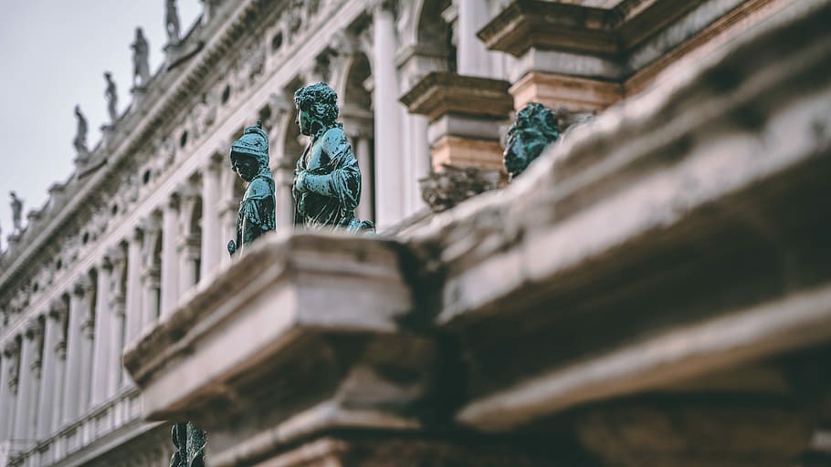 human statues near white building, selective focus photography of two blue statues HD wallpaper