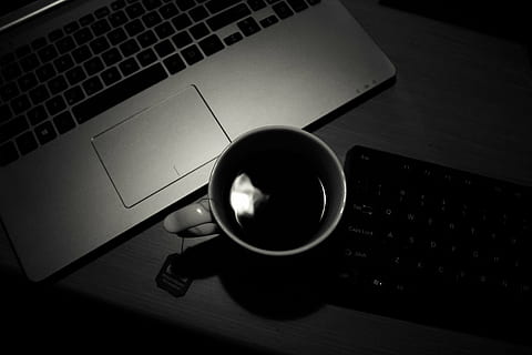 white ceramic mug filled with coffee near laptop computer, still life HD wallpaper