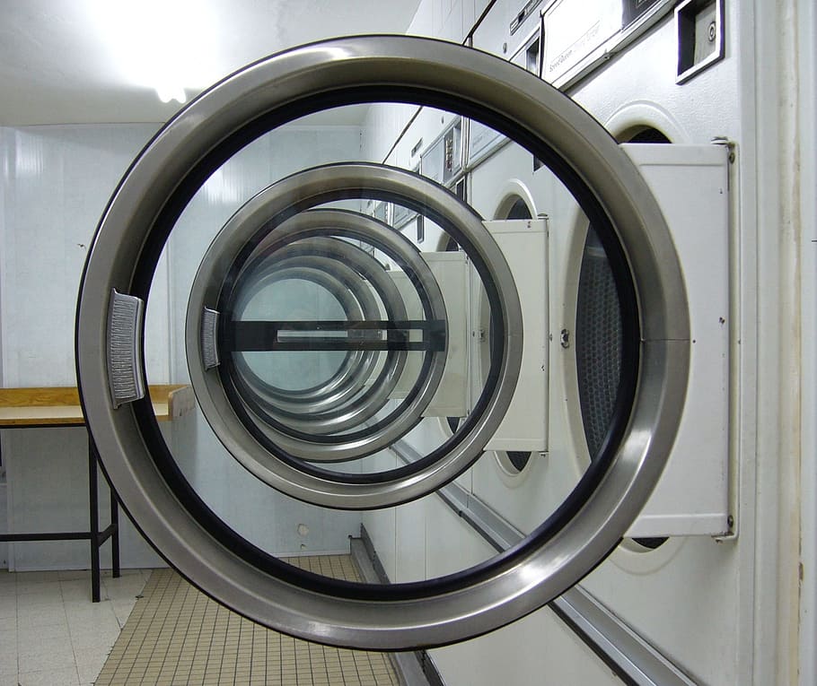 close up photo of washing machines, laundromat, circles, laundry machine