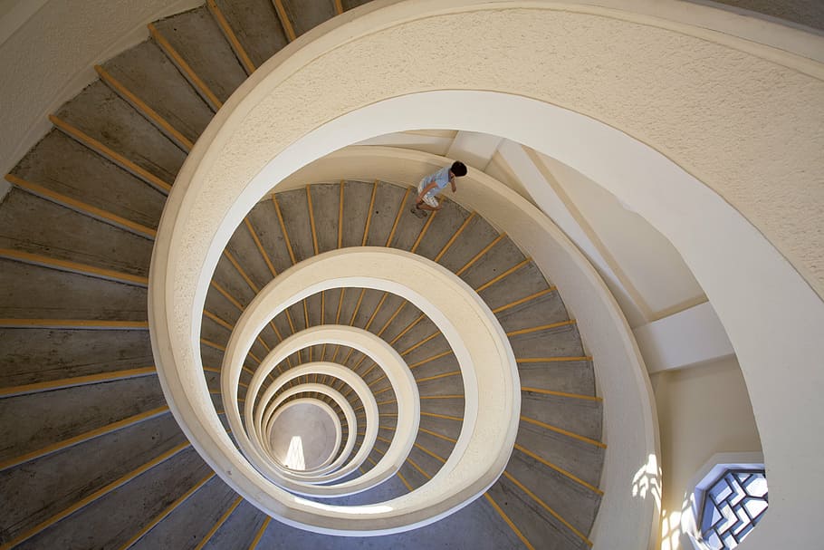 boy going down a spiral concrete staircase, composition, chinesegarden