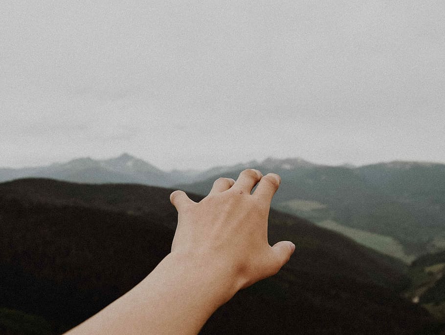 person reaching out hand, left human hand raising nearby mountains HD wallpaper