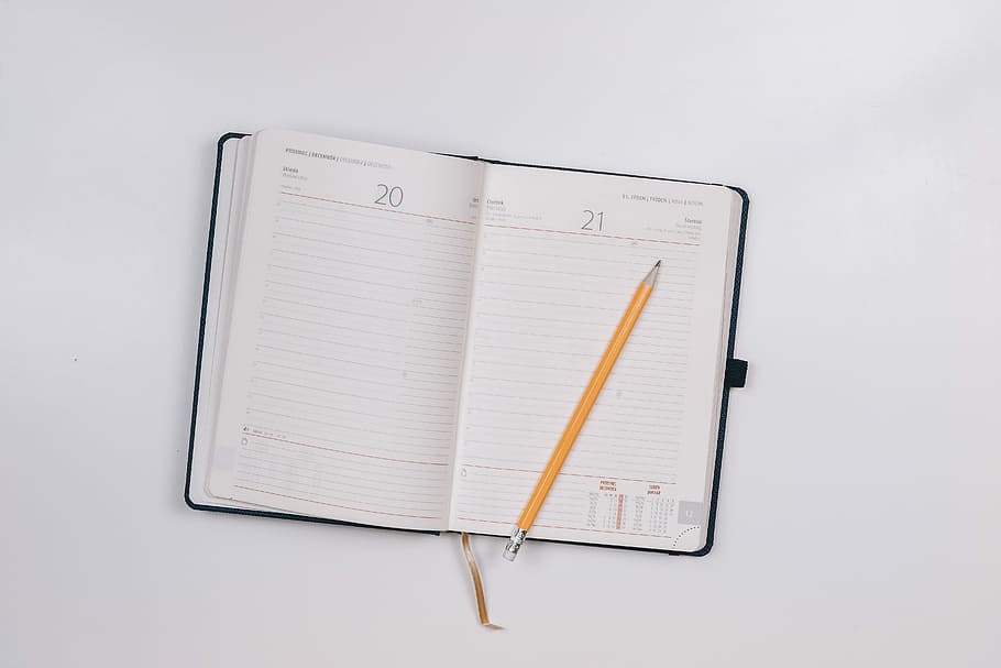 pencil on opened notebook, yellow pencil on white ruled book HD wallpaper