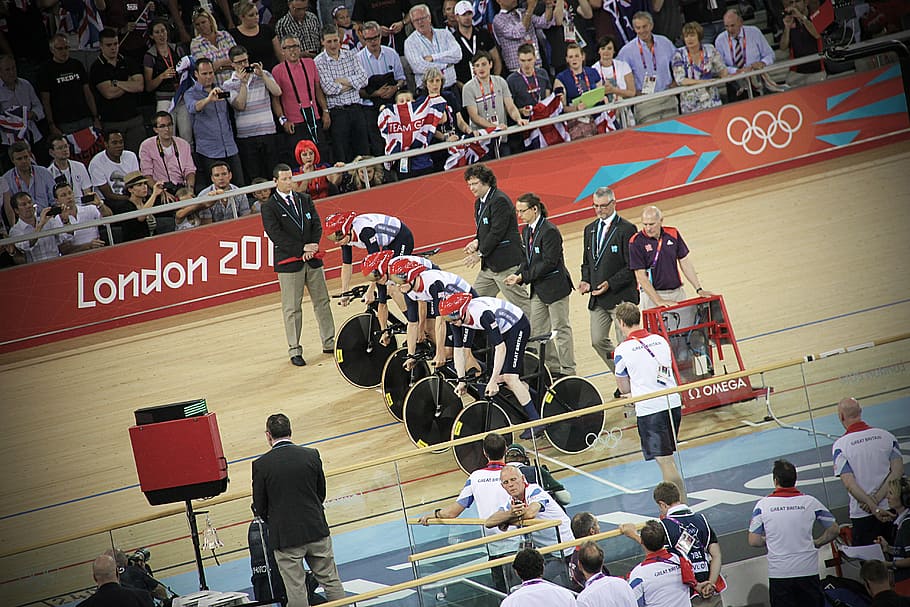 men riding bicycles on starting line at track, crown watching London Olympic cycling sports