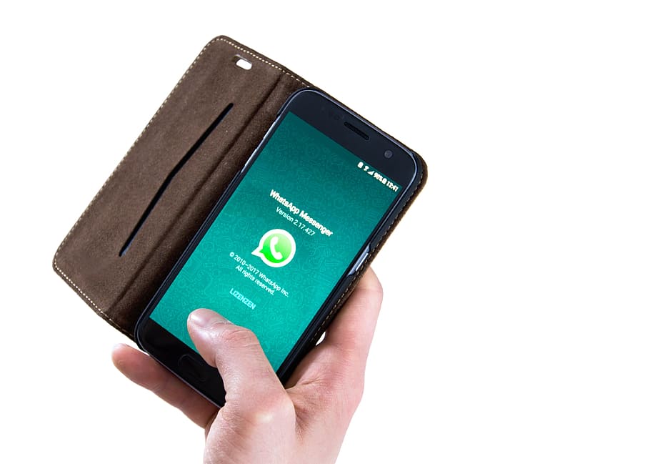 person holding phone displaying WhatsApp messenger, technology HD wallpaper