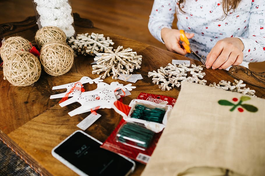 assorted decors on table, woman cutting a Christmas decors, craft HD wallpaper