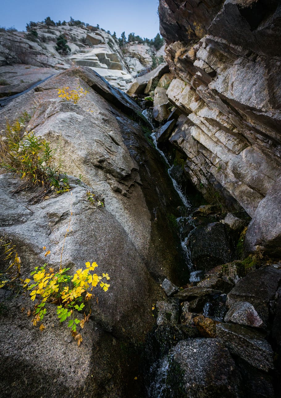 low angle photography of rocky cliff during daytime, waterfall HD wallpaper