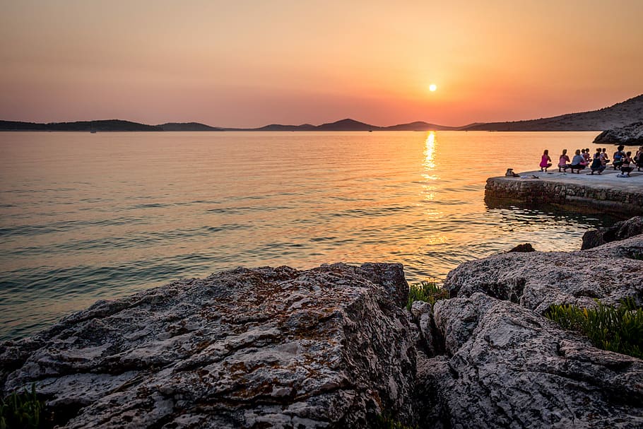 Yoga by the sunset, people at seashore during sunset, seaside HD wallpaper