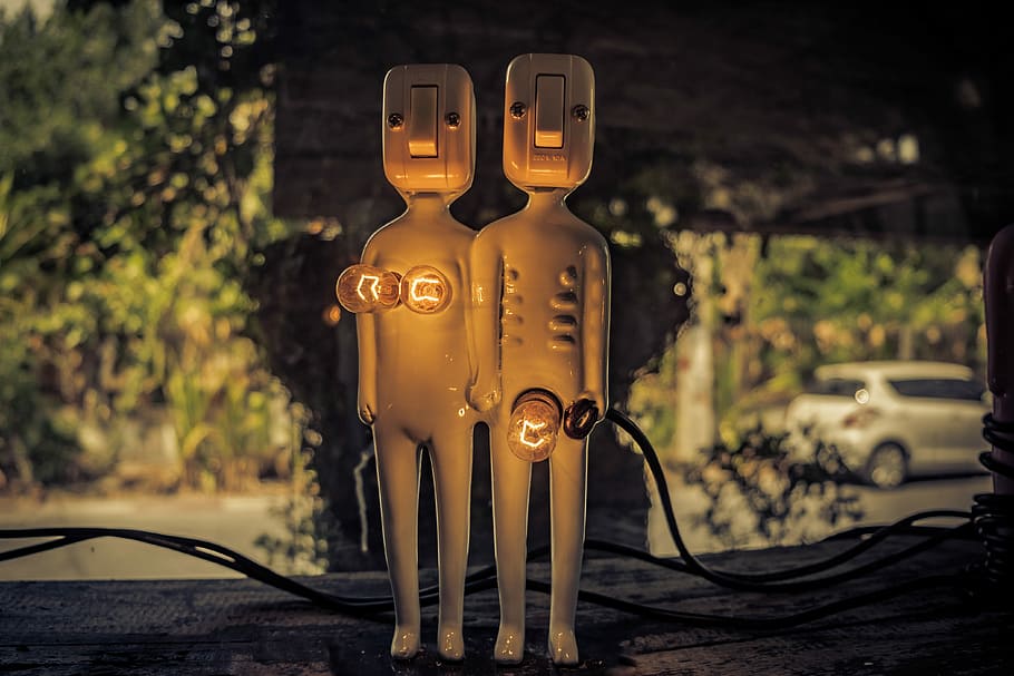 lighted switch character decor, selective focus photography of male and female figure table lamp with switch