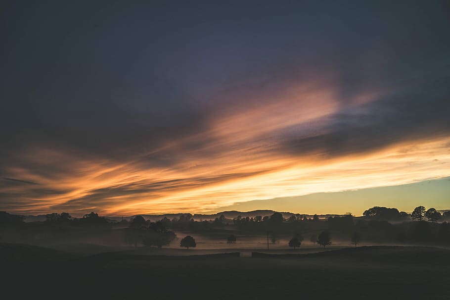 silhouette of trees and mountain under cloudy sky, sunset view on terrain HD wallpaper