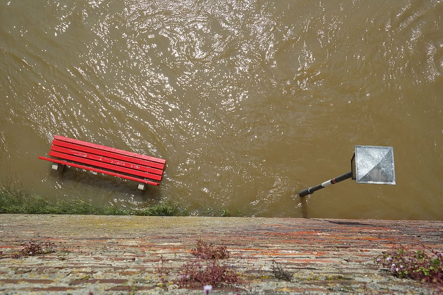 red bench chair drowned with water, high water, park bench, street lamp