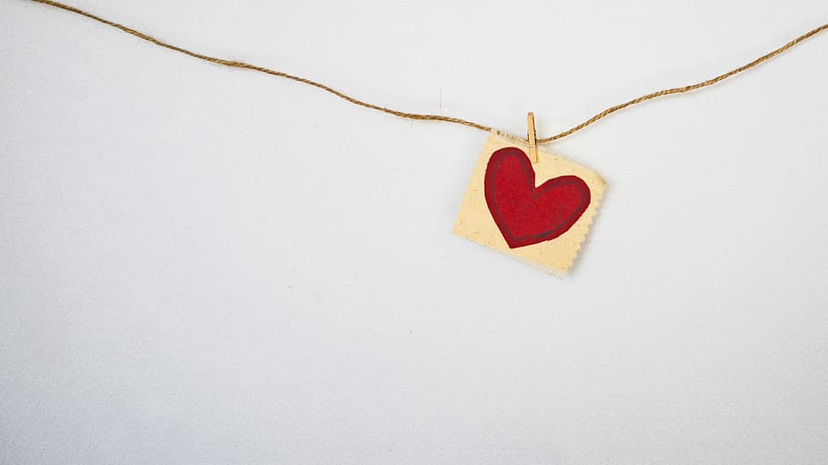 heart-shaped red and beige pendant, photo of paper with heart drawing hanged on wall HD wallpaper