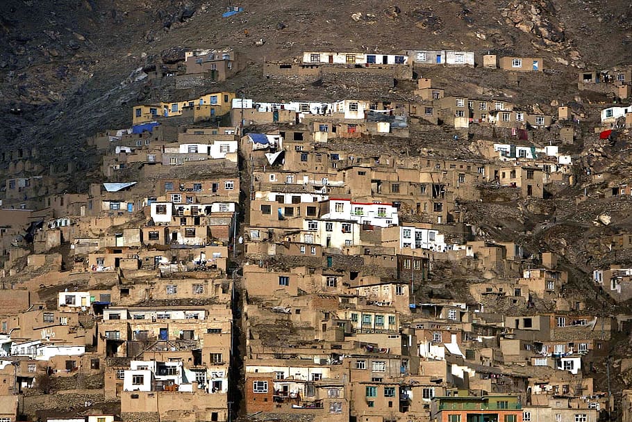 white and brown concrete house beside mountain, afghanistan, houses