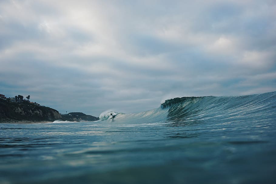 person surfing with wave during cloudy day, photography of wave HD wallpaper