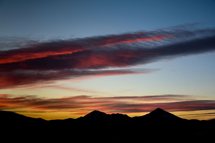 silhouette of mountains under orange and blue sky, highland HD wallpaper
