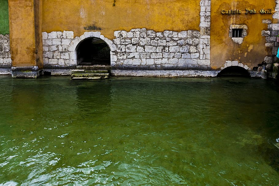 white and orange concrete structure beside body of water, body of water near yellow wall HD wallpaper