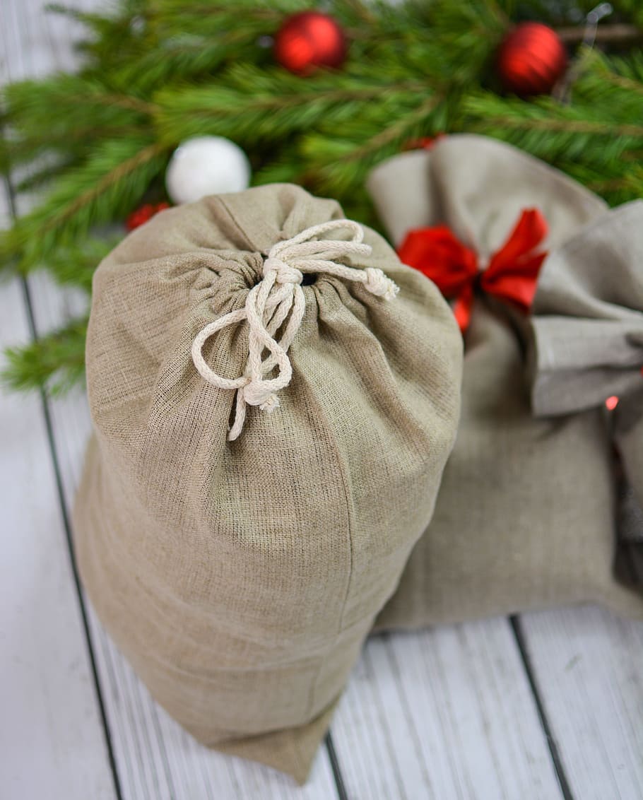 top view of brown drawstring pouch on white wooden surface HD wallpaper