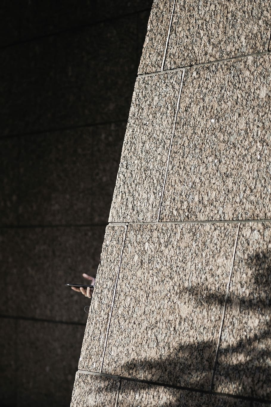 person holding smartphone hiding on wall, stone, hand, sunlight HD wallpaper