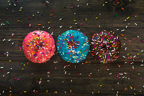 three donuts with sprinkle toppings, three assorted-color donuts with sprinkles HD wallpaper