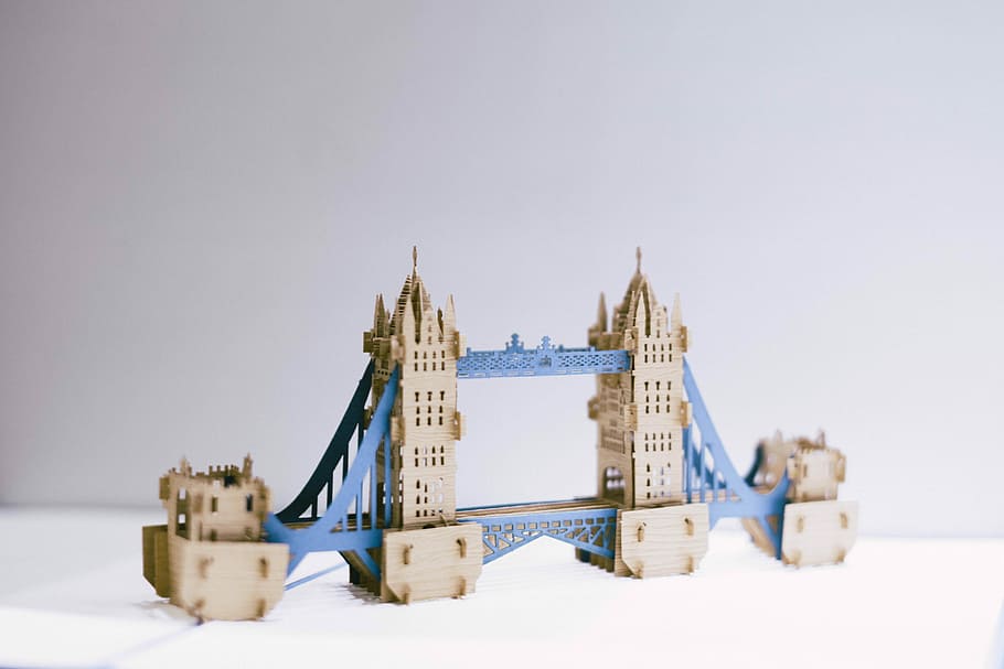 brown and blue bridge figure tower, brown and blue bridge toy on white surface HD wallpaper