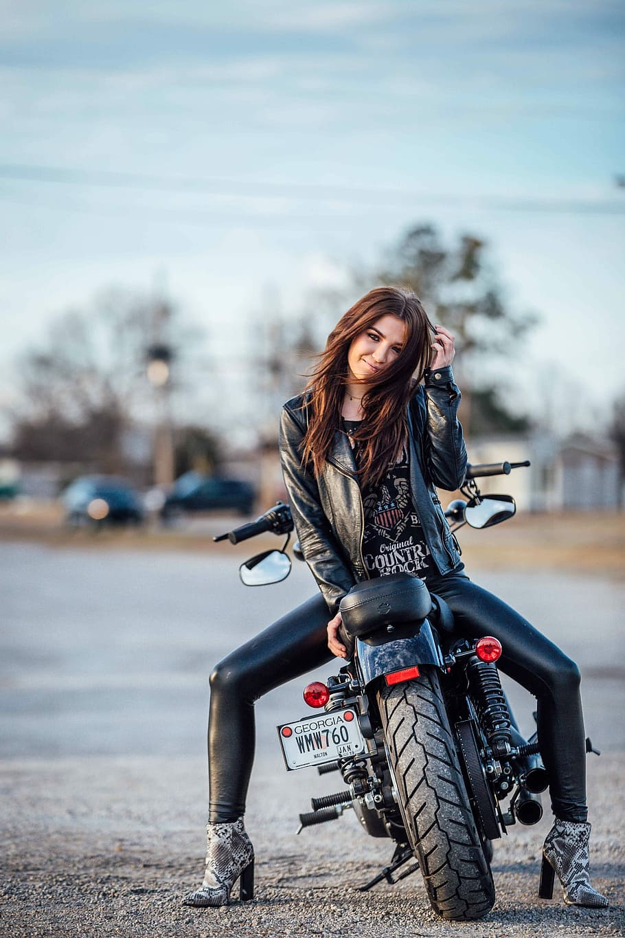 woman sitting on black motorcycle, bike, backwards, caucasian