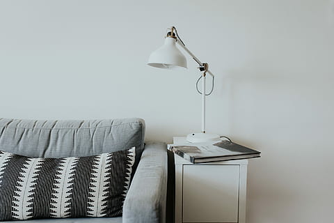 white desk lamp near gray fabric couch, book on table with table lamp beside sofa HD wallpaper