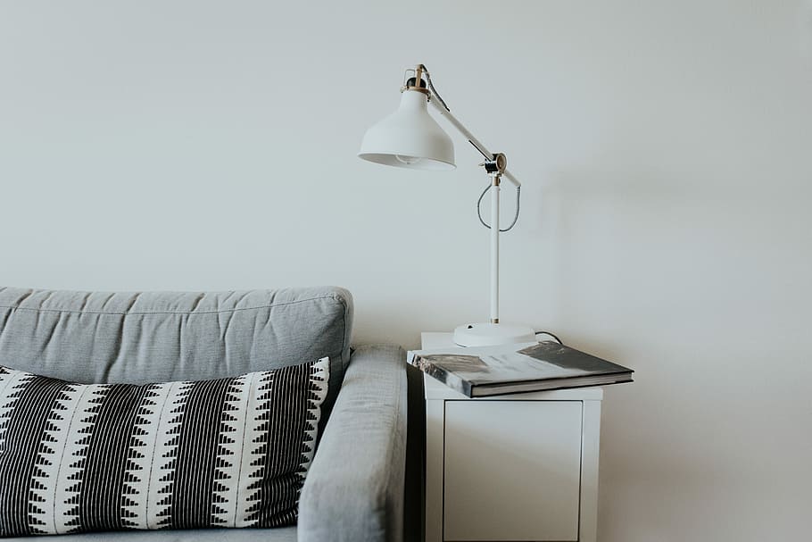 white desk lamp near gray fabric couch, book on table with table lamp beside sofa HD wallpaper