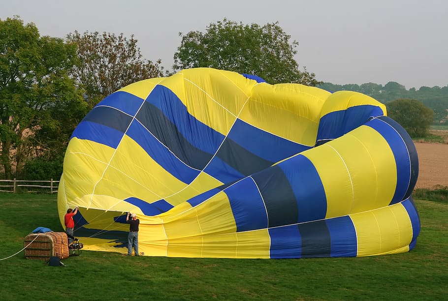 blue and yellow hot air balloon near trees, aerospace, aircraft, HD wallpaper