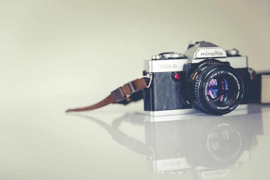 black and grey Minolta bridge camera on white surface, black Minolta MILC camera HD wallpaper