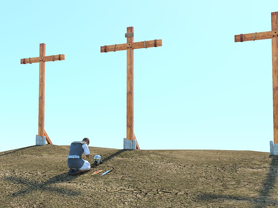 man kneeling on floor in front of cross in mountain, legionnaire