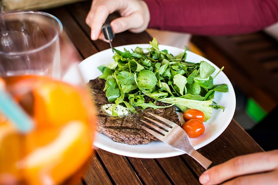 Barbequed beef steak with greens, eating, grilling, hands, meat HD wallpaper