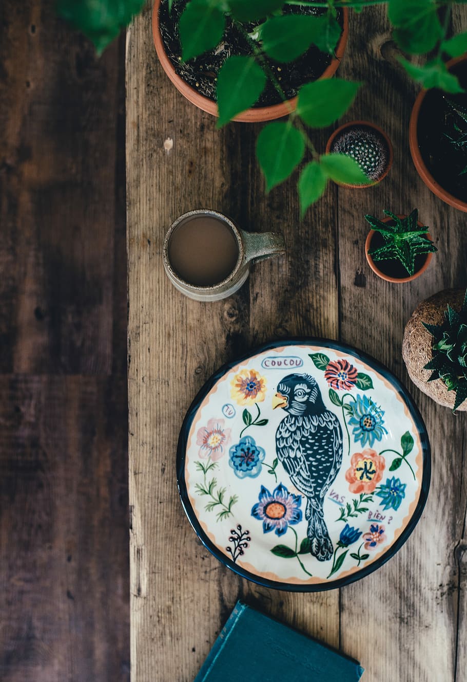 top view photo of black and multicolored bird painting with flower theme, bird painting on table HD wallpaper