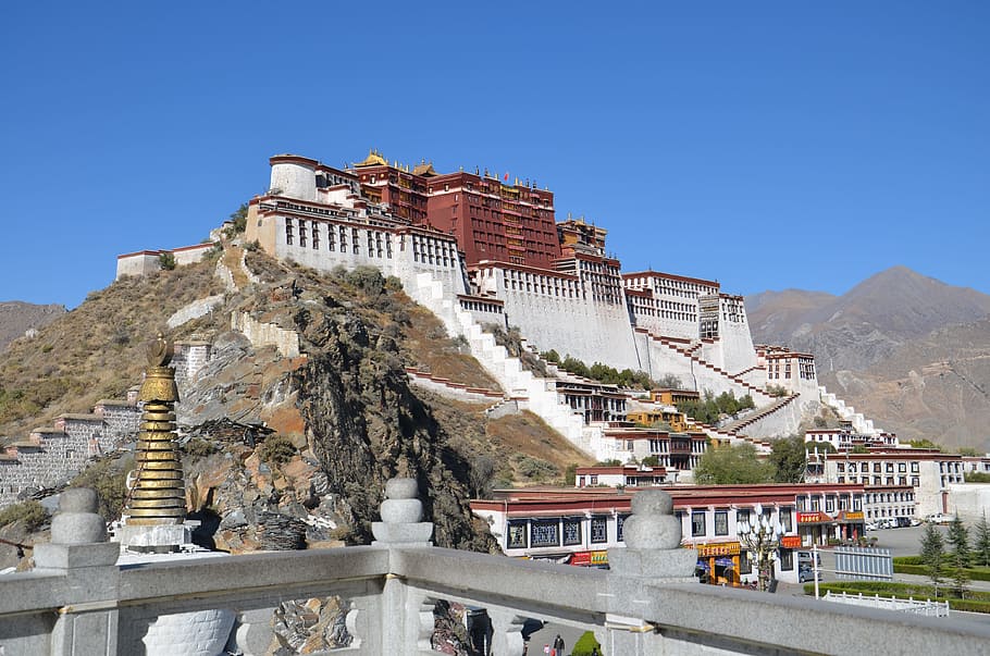 architectural photography of red and white temple, tibet, lhasa