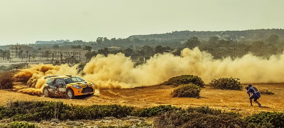 racing car on open field during daytime, rally, photographer