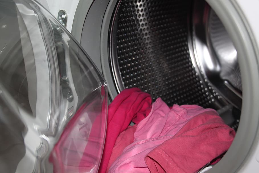 pink shirt in clothes washer, washing machine, washing drum, close-up