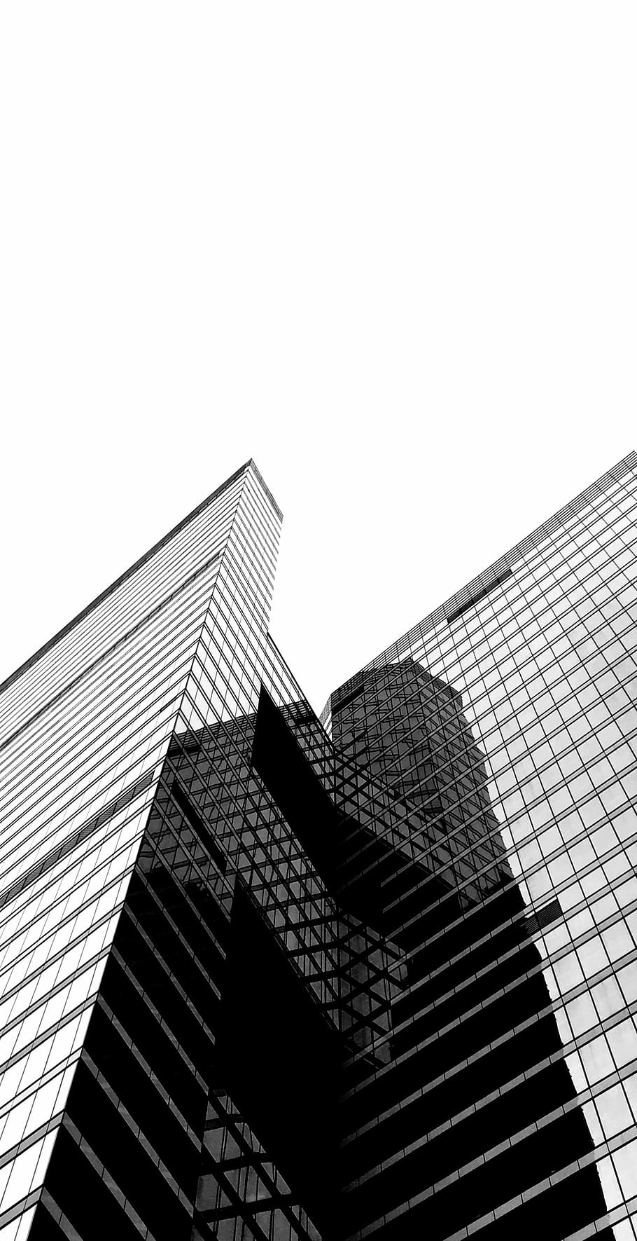 low-angle photography of high-rise building, black and white photo of concrete building HD wallpaper