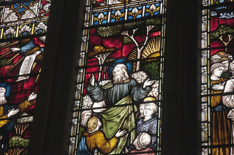 low-angle photography of church stained glass window, photo of religious paintings