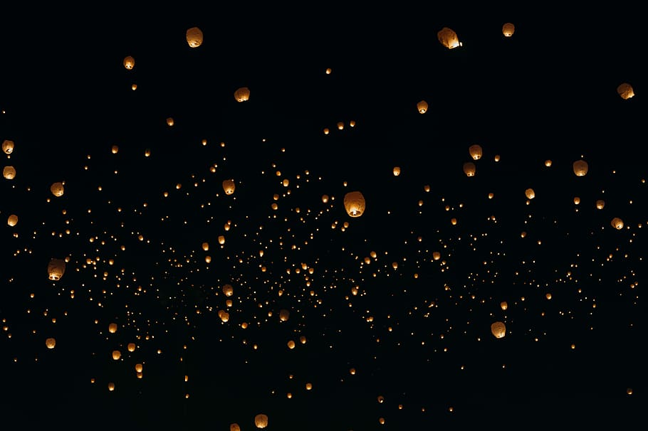 floating paper lanterns on sky during nighttime, assorted sky lanterns at nighttime