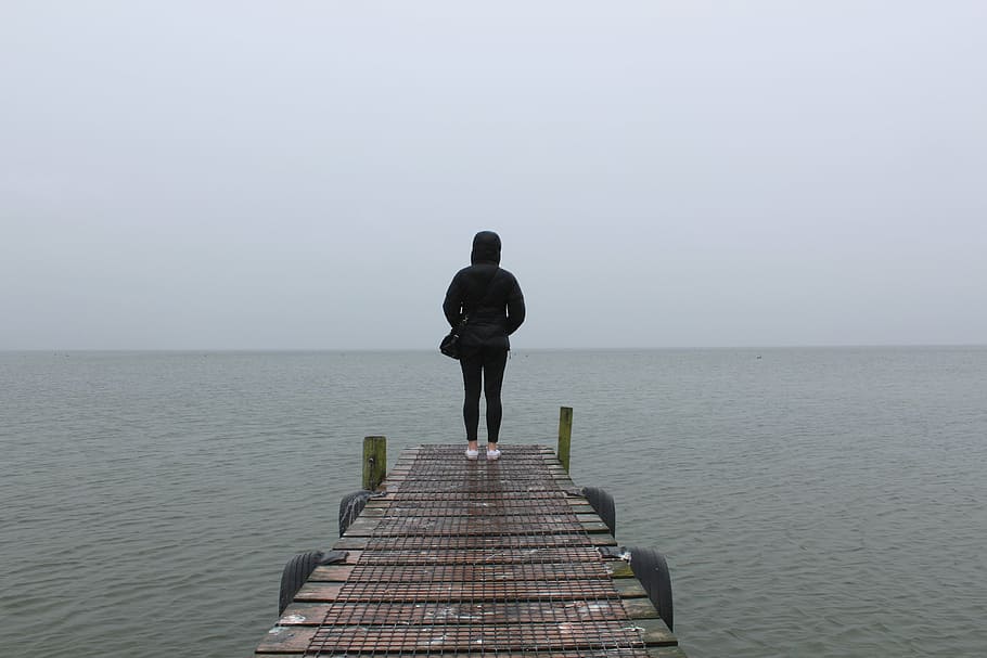 person standing on dock during daytime, woman, black, hoodie, HD wallpaper