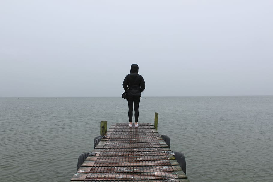 Hd Wallpaper Person Standing On Dock During Daytime Woman Black Hoodie Wallpaper Flare 